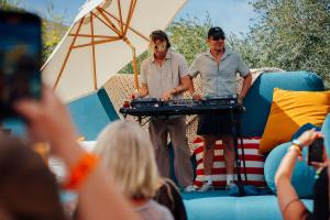 NEIL FRANCES performing on the giant couch at the Billboard and Amazon Pop-up Party held at Ace Hotel & Swim Club Palms Springs on April 12, 2025 in Palm Springs California.