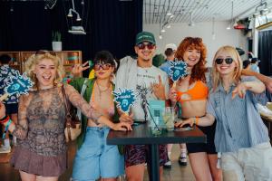 Party guests ‘fanning out’ at the Billboard and Amazon Pop-up Party held at Ace Hotel & Swim Club Palms Springs on April 12, 2025 in Palm Springs California
