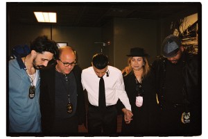 Alejandro (center) with family and friends backstage at Kaseya Center on May 30 in Miami. From left: friend Francis Diaz, uncle Rodny, mom Maria Nelly, and assistant Jose Rosa.