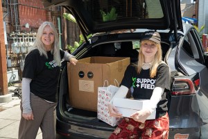 Maggie Baird and Hayley Williams of Paramore deliver meals on June 28, 2023, as part of Baird’s volunteer work for her nonprofit organization, Support+Feed.