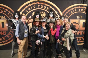 KISS posing with fans during a VIP experience on the band’s End of the Road Tour in 2023.