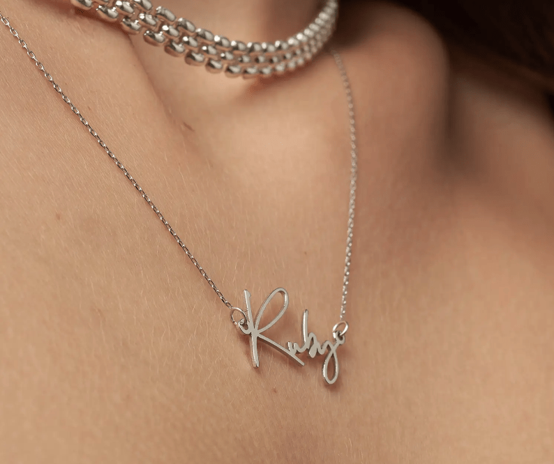 model wearing silver nameplate neckalce